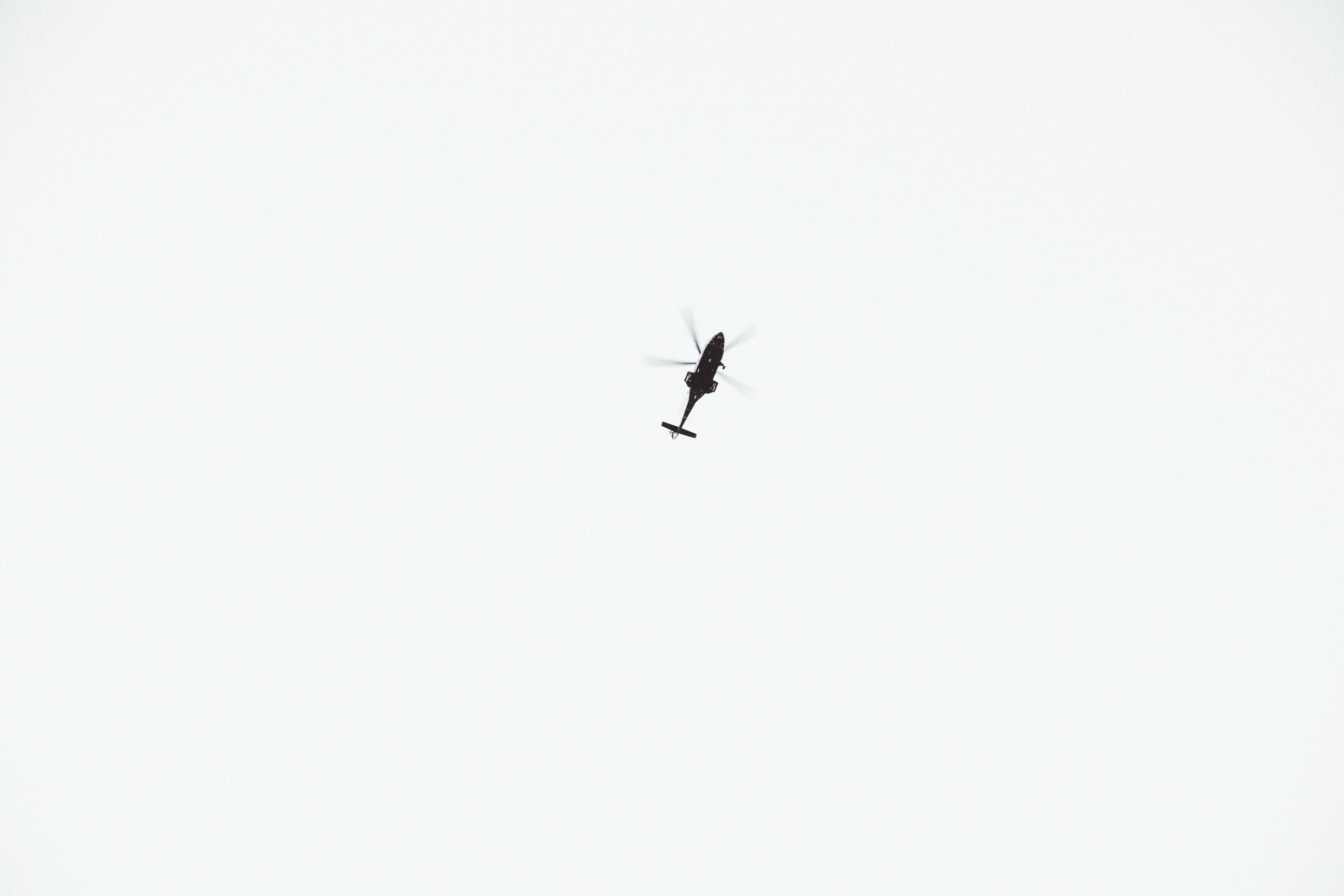 black helicopter on sky during daytime